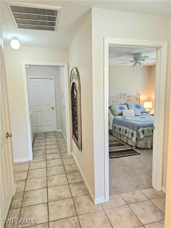 hall featuring light tile patterned floors