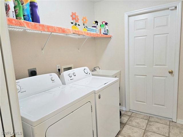 laundry room with washing machine and dryer, sink, and light tile patterned floors