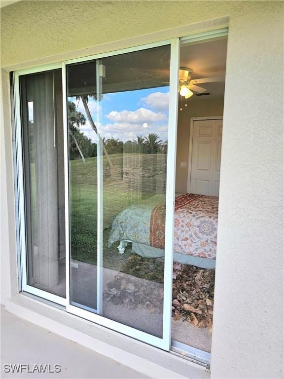 doorway to outside featuring ceiling fan