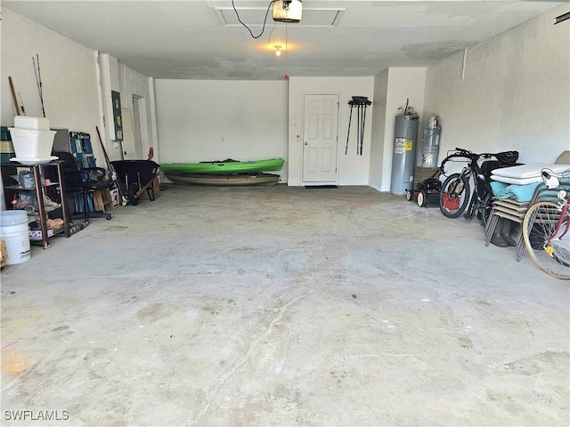 garage featuring a garage door opener, electric panel, and water heater