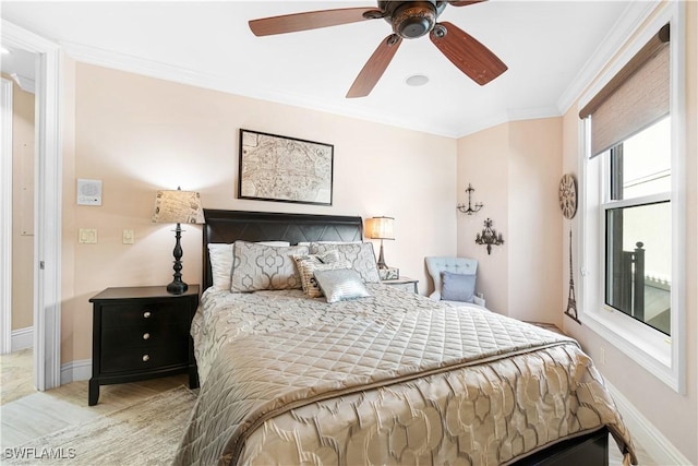 bedroom with ceiling fan and ornamental molding