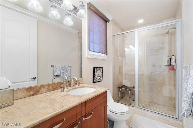 bathroom featuring crown molding, vanity, toilet, and an enclosed shower