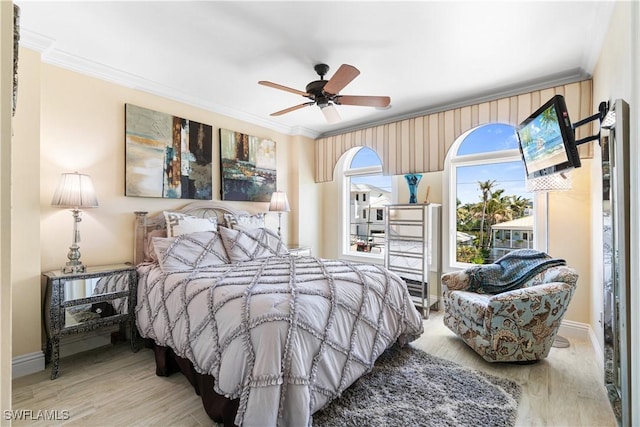 bedroom featuring crown molding, light hardwood / wood-style flooring, and ceiling fan