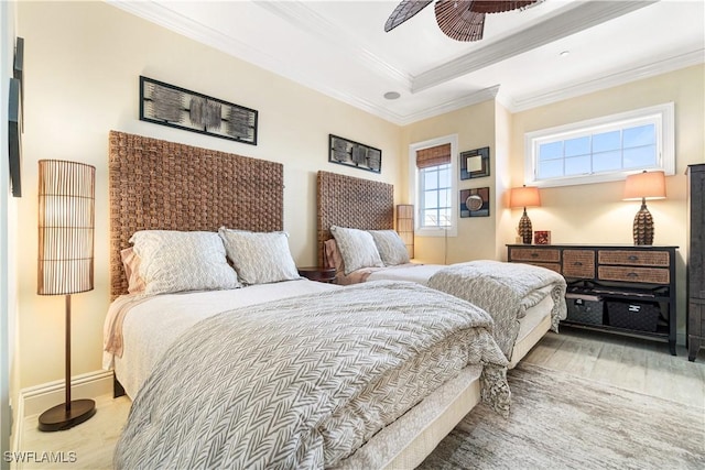 bedroom featuring ceiling fan, ornamental molding, and a tray ceiling