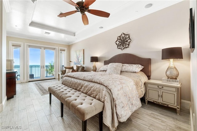 bedroom with access to exterior, crown molding, light hardwood / wood-style floors, and a raised ceiling