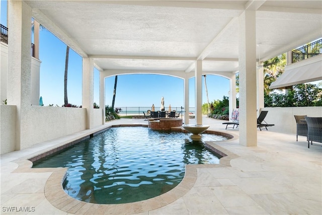 view of swimming pool with a water view