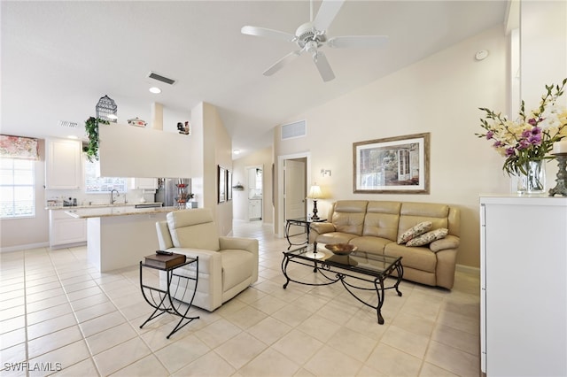 tiled living room with high vaulted ceiling, sink, and ceiling fan