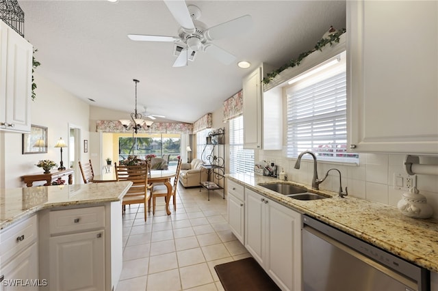 kitchen with stainless steel dishwasher, light tile patterned floors, sink, and white cabinets