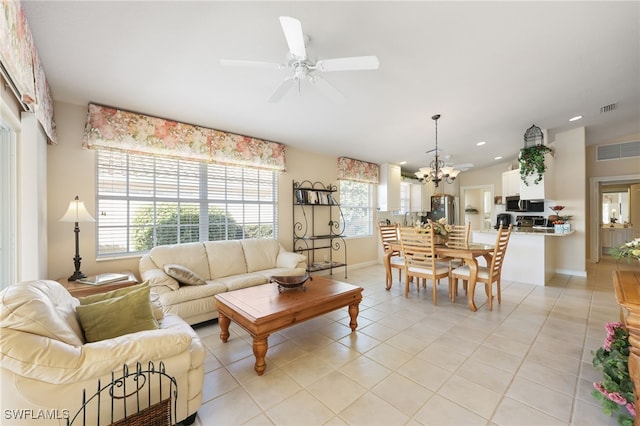 living room featuring light tile patterned floors and ceiling fan with notable chandelier