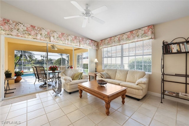 tiled living room with ceiling fan and lofted ceiling