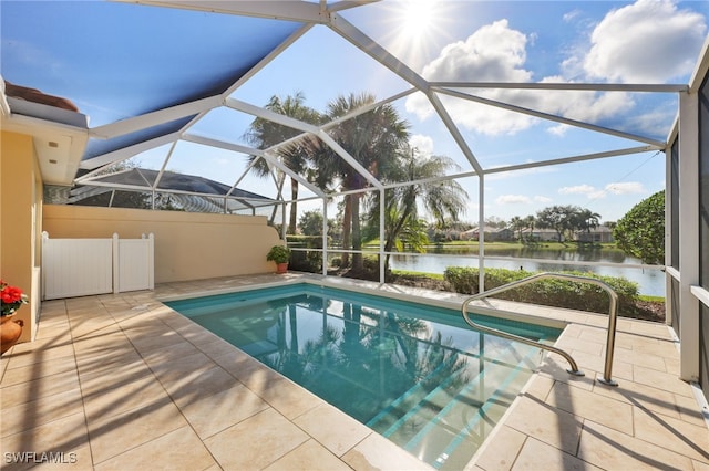 view of pool with a patio, a water view, and glass enclosure