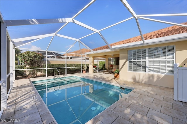 view of pool featuring a patio area and glass enclosure