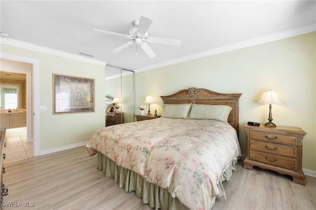 bedroom with crown molding, light hardwood / wood-style flooring, ceiling fan, and a closet