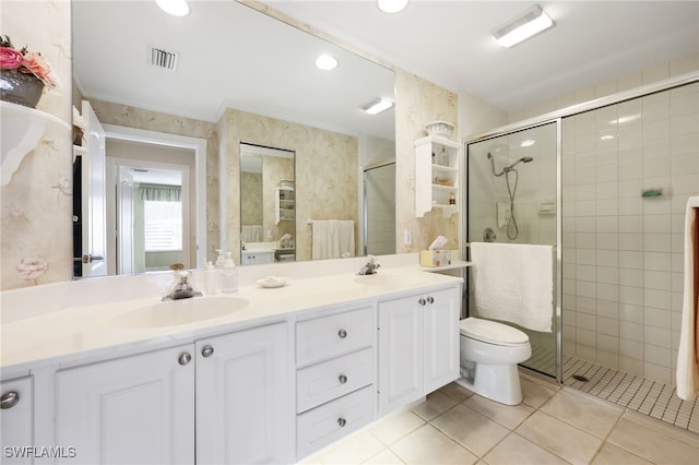 bathroom featuring vanity, toilet, tile patterned floors, and walk in shower