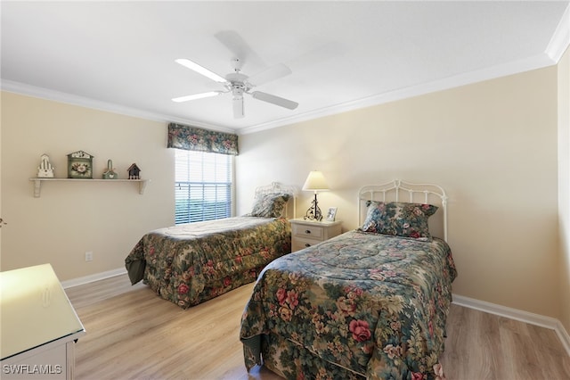 bedroom featuring crown molding, ceiling fan, and light hardwood / wood-style flooring