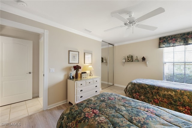 bedroom featuring ornamental molding, ceiling fan, and light wood-type flooring