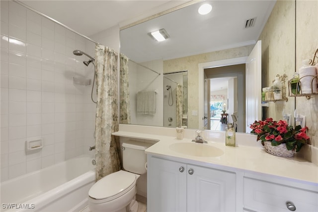 full bathroom with vanity, shower / bath combo, and toilet