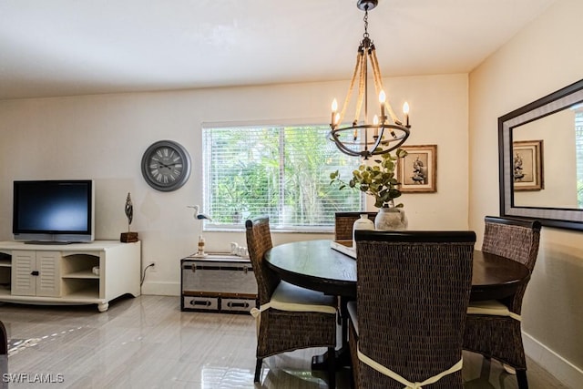 dining space featuring baseboards and an inviting chandelier