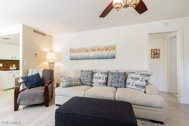 living area with ceiling fan and visible vents