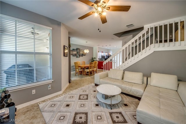 tiled living room with ceiling fan