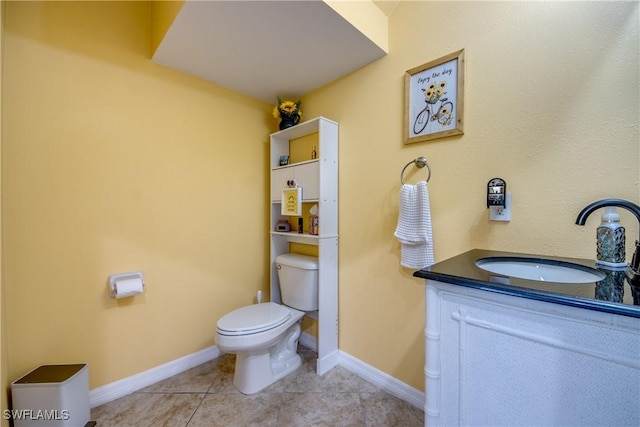 bathroom featuring vanity, tile patterned floors, and toilet