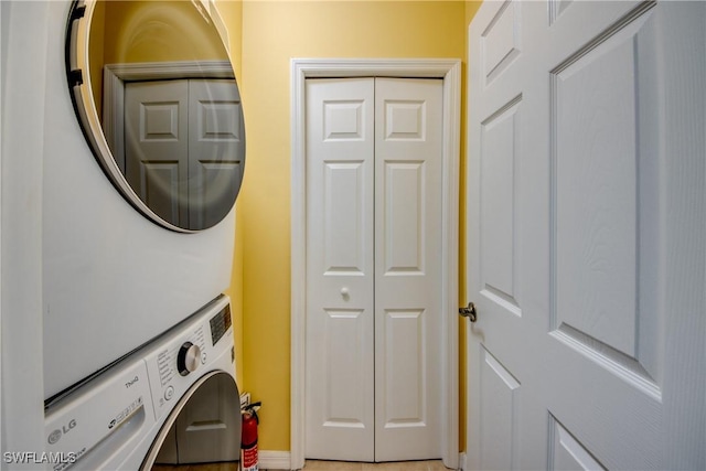 laundry area with stacked washer / drying machine