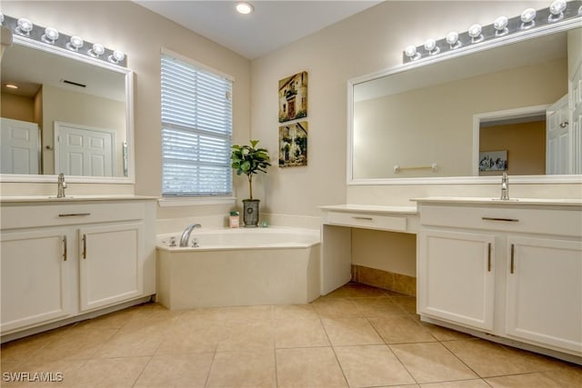 bathroom with vanity, tile patterned floors, and a tub