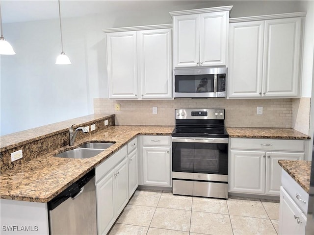 kitchen featuring sink, white cabinets, decorative backsplash, hanging light fixtures, and stainless steel appliances