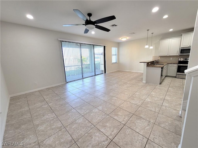 interior space featuring pendant lighting, ceiling fan, appliances with stainless steel finishes, white cabinetry, and light tile patterned flooring