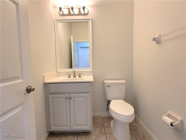 bathroom with vanity, tile patterned flooring, and toilet