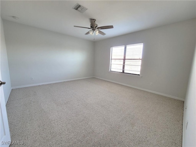 carpeted spare room featuring ceiling fan