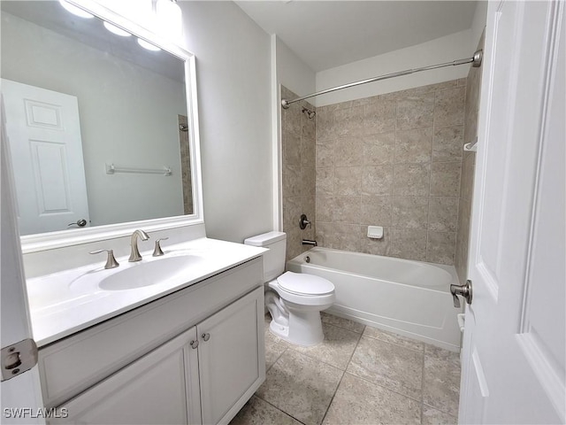 full bathroom with vanity, tiled shower / bath combo, and toilet