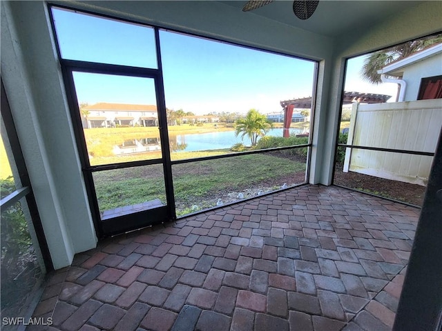 unfurnished sunroom with a water view