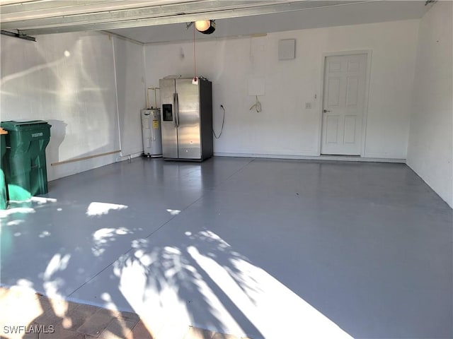 garage with a garage door opener, electric water heater, and stainless steel fridge