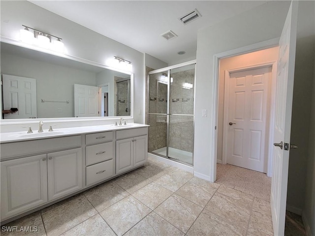 bathroom featuring vanity and an enclosed shower