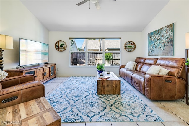 tiled living room featuring ceiling fan and vaulted ceiling