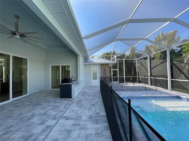 view of pool featuring exterior kitchen, a patio, a lanai, and ceiling fan