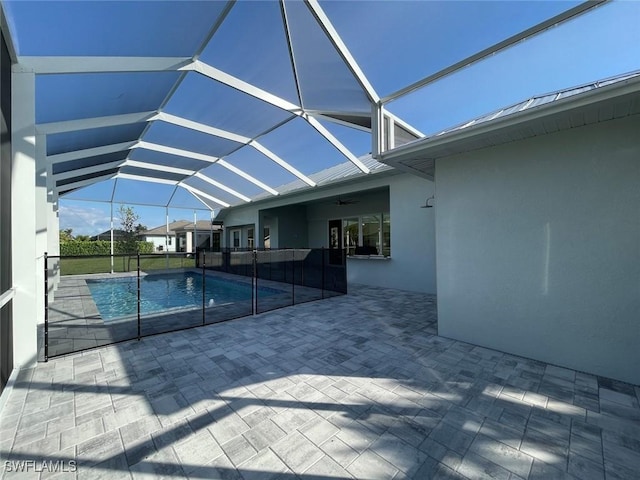 view of pool featuring a lanai, ceiling fan, and a patio area