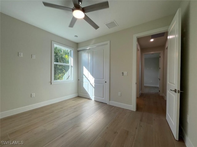 unfurnished bedroom with a closet, ceiling fan, and light hardwood / wood-style flooring