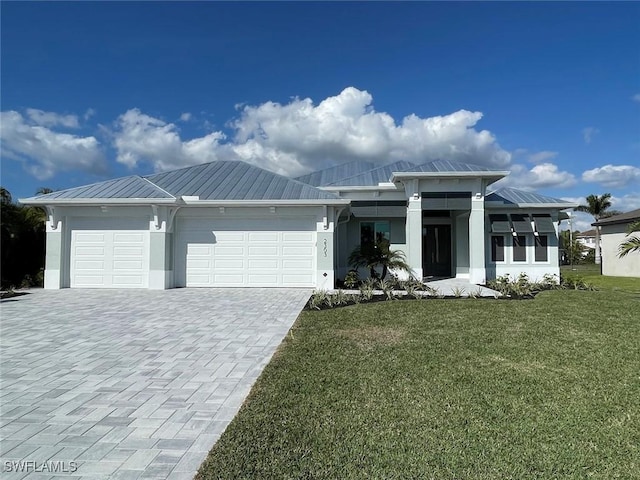 view of front of house featuring a garage and a front lawn