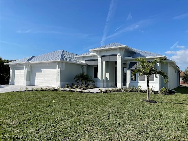 view of front of house with a garage and a front yard