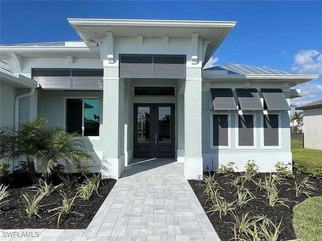 view of exterior entry featuring french doors