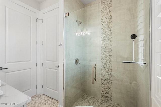 bathroom featuring a shower with door