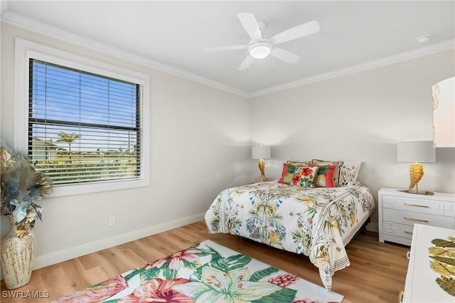 bedroom with hardwood / wood-style floors, crown molding, and ceiling fan