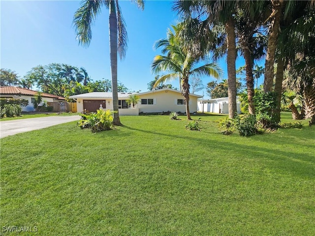 exterior space with a garage and a front lawn