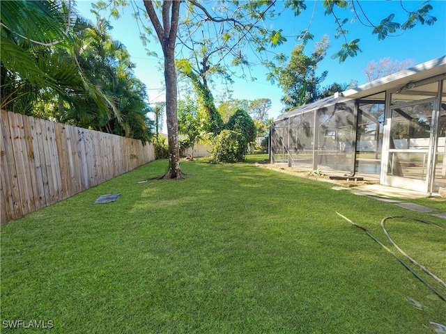 view of yard with glass enclosure