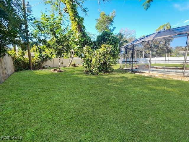 view of yard with a lanai