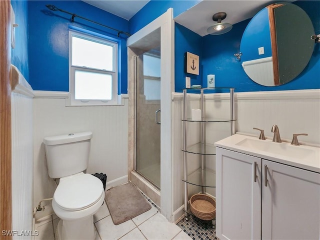 bathroom with vanity, toilet, an enclosed shower, and tile patterned flooring