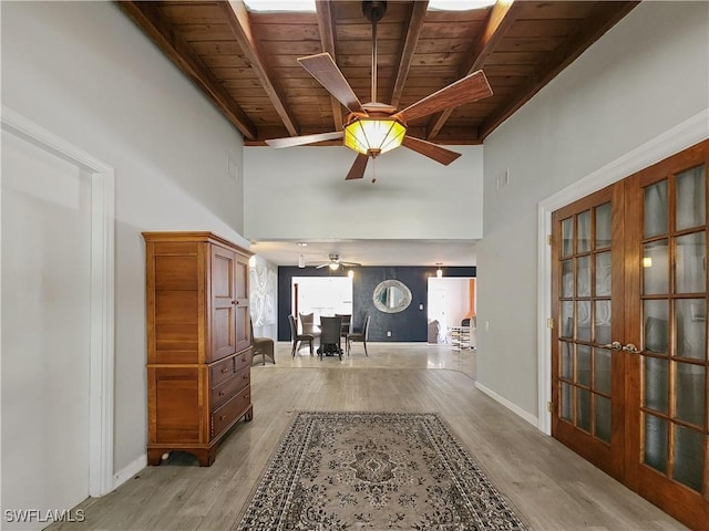 corridor featuring beam ceiling, wood ceiling, and light hardwood / wood-style flooring