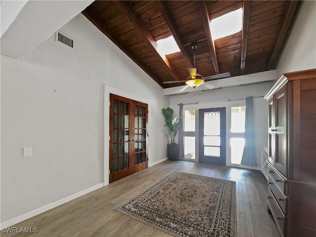 entryway featuring french doors, beamed ceiling, hardwood / wood-style floors, and wooden ceiling